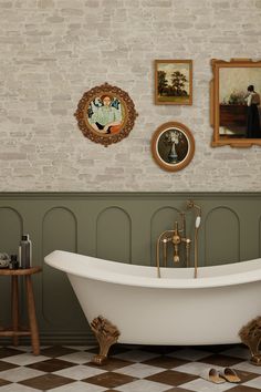 Vintage-inspired bathroom featuring a clawfoot tub with brass fixtures, green wainscoting, exposed brick wall, and checkerboard flooring. Vintage Clawfoot Tub Bathroom, Clawfoot Tub Bathroom Vintage, Green Wainscoting, Bathroom Clawfoot Tub, Bathroom With Clawfoot Tub, Clawfoot Tub Bathroom, Vintage Clawfoot Tub, Vintage Inspired Bathroom, Brick Accent Wall