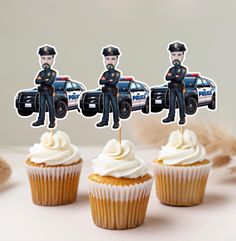 three cupcakes with police officers on top are sitting in front of each other