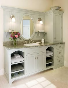 a white bathroom with two sinks and mirrors