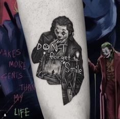 a person with a joker tattoo on their arm that says don't forget to smile