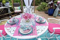 the table is set with pink and blue place settings