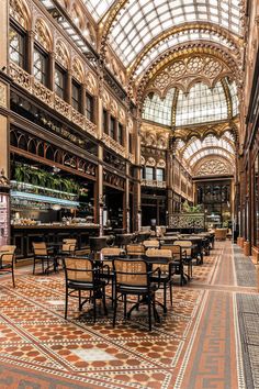 the inside of a building with many tables and chairs