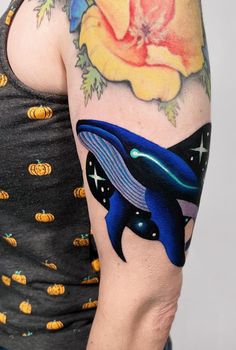 a man with a tattoo on his arm has an orca whale and pumpkins