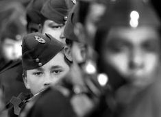 a black and white photo of a group of men in uniform looking at the camera