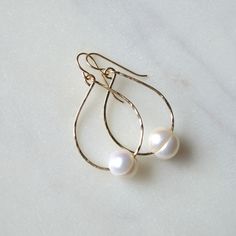 "These simple but gorgeous freshwater pearl earrings feature white or silver freshwater pearls strung onto 19g gold filled or sterling silver wire. Pearls measure approximately 10-11mm and teardrops are 1.25\" long. Please note that pearls are imperfect. They have lines and are not perfectly round." Minimalist Teardrop Pearl Charm Earrings, Minimalist Teardrop Pearl Earrings With Charm, Teardrop 14k Gold Filled Pearl Earrings For Anniversary, Teardrop 14k Gold-filled Pearl Earrings For Anniversary, 14k Gold Filled Teardrop Pearl Earrings For Anniversary, Everyday Teardrop Pearl Pendant Earrings, Everyday Minimalist Pearl Drop Teardrop Earrings, Dainty Teardrop Pearl Earrings For Everyday, Minimalist Hypoallergenic Teardrop Pearl Earrings