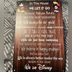 a wooden sign that says in this house we let it go and the bear necessities will always be our guide