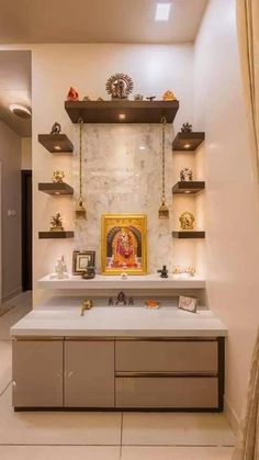 a white counter with shelves on each side and a gold framed painting above it in the middle