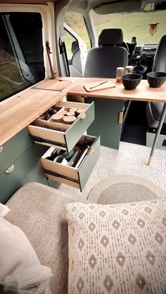 the interior of a van with drawers and desks in it's center area