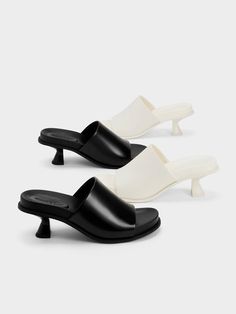 These Clio mules are modern minimalism at its best. The subtly curved contours, slant heels and pristine chalk-white finish come together to accentuate the sleek and architectural silhouette of these elegant and understated shoes. Plus points for the cushioned cleated soles that offer comfort for all-day walking. Pair them with cropped trousers or a midi skirt to highlight their sculptural aesthetic. Heel Mules, Chalk White, Modern Minimalism, Charles Keith, Cropped Trousers, Clogs, Chalk, Midi Skirt, Walking