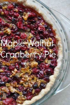 a pie with cranberry topping in a glass pie dish on top of a table