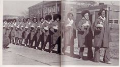 an old black and white photo of women in uniforms