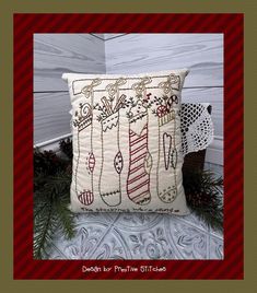 a decorative pillow with christmas stockings on it