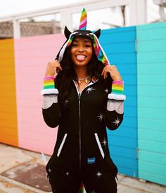 a woman wearing a unicorn hat and black sweat suit