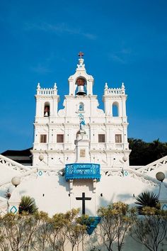 a white church with a blue cross on the front