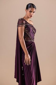 Burgundy lycra and net draped saree gown with Swarovski, crystals, cutdana and sequins hand embroidery. - Aza Fashions Pre-draped Embellished Fitted Evening Dress, Fitted Embellished Pre-draped Evening Dress, Fitted Traditional Drape Evening Dress For Gala, Fitted Gown With Traditional Drape For Gala, Embellished Fitted Pre-draped Saree For Gala, Fitted Dress With Traditional Drape For Evening, Fitted Asymmetrical Pre-draped Gown, Fitted Pre-draped Asymmetrical Gown, Festive Draped Fitted Evening Dress