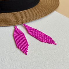 These fuschia beaded earrings with fringe are created for lovers of bright summer accessories. Inspired by tribal style, these statement waterfall earrings are made from high-quality Czech seed beads and supplied with stainless steel accessories. This pair would be a great choice if you need bold seed bead earrings or an accessory in hot pink, neon pink, or magenta color. 100% top-quality handmade earrings.  Materials:  - Czech beads - stainless steel closure. Length: 3.94'' / 10 cm Width: 0.8'' / 2 cm The real color of the item may be slightly different from the picture shown on website caused by the brightness of your monitor. If you have special size requirements, please send me a letter about it, as this can be made to order. More beadwork earrings: https://etsy.me/30peGhg Back to shop Magenta Earrings, Summer Earrings, Summer Earring, Pink Summer, Seed Bead Earrings, Czech Beads, Bead Earrings, Summer Accessories, Chandelier Earrings