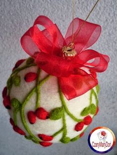 an ornament hanging from the ceiling with a red bow on it's head