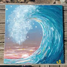 an acrylic painting of a wave in the ocean on a wooden planks