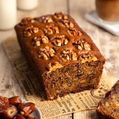 a loaf of bread sitting on top of a table next to some raisins