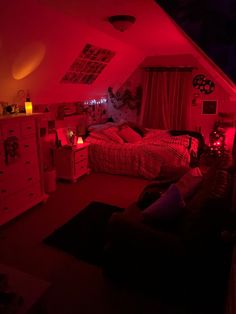 an attic bedroom with red lights on the ceiling