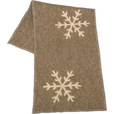 a brown and white snowflaked towel on top of a wooden tablecloth