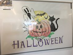 a halloween sign is hanging on the wall