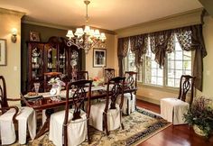 a formal dining room set up with white tablecloths