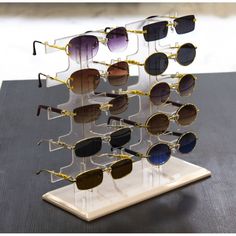 several pairs of sunglasses are displayed on a table