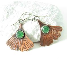 "Earthy and rustic yet refined copper ginkgo leaf earrings feature lovely minty green adventurine cabochons. The ear wires are standard 20 gauge sterling silver ear wires. Crafted from copper sheet stock, sterling silver and natural green adventurine. They are finished with an oxidation patina to define their texture and add depth, The ear wires allow for a nice swingy movement. Perfect to wear to the office, around town or a relaxed weekend. Also a wonderful gift idea for a traditional 7th anni Green Stone Earrings, Metalsmith Jewelry, Metalsmithing Jewelry, Mixed Metal Earrings, Minty Green, Ginkgo Leaf, Earrings Inspiration, Party Earrings, Moonstone Earrings