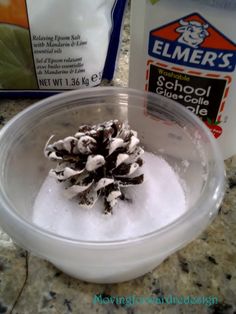 a bowl filled with snow next to a bag of flour