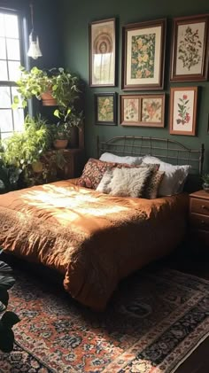 a bedroom with green walls and pictures on the wall