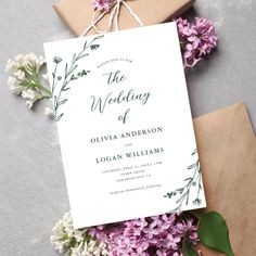 the wedding stationery is laid out on top of envelopes and tied with twine