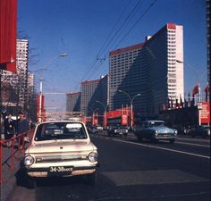 an old car is driving down the street