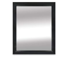 a black framed mirror on a white wall