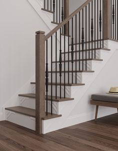 a white staircase with wooden handrails next to a gray bench and brown wood flooring