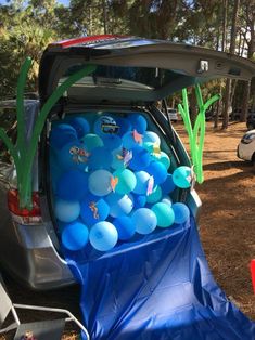 the trunk of a car is filled with balloons