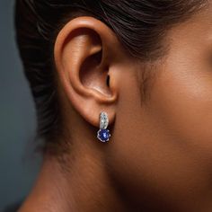 Elevate your style with these stunning earrings featuring natural blue sapphires set in luxurious 18K white gold. Each earring showcases two exquisite sapphires totaling 1.75 carats, complemented by sparkling diamonds for a touch of brilliance.  Earring Highlights: Total Carat Weight: 1.75 carats of vivid blue sapphires, offering a rich and captivating hue. Shape: Round, providing a classic and elegant appearance. Dimensions: 5.9 x 5.9 mm, perfectly sized to highlight the sapphires' natural beauty. Color: Blue, with a vivid intensity that emphasizes the gemstones' deep and enchanting shade. Clarity: Very eye clean, ensuring a clear and brilliant view. Cut: Brilliant/Step cut, designed to enhance the sapphires' natural sparkle. Treatments: Heated, to improve the sapphires' color while maint Sapphire Tanzanite Earrings Fine Jewelry, Fine Jewelry Sapphire Tanzanite Earrings, Fine Jewelry Tanzanite Earrings In Sapphire Color, White Gold Tanzanite Gemstone Earrings, White Gold Tanzanite Earrings With Brilliant Cut, Blue Tanzanite Round Earrings, Blue Diamond Earrings With Prong Setting, Blue Sapphire Diamond Earrings With Brilliant Cut, Sapphire Drop Earrings With Brilliant Cut