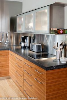 a kitchen with stainless steel appliances and wooden cabinets