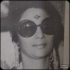 an old photo of a woman with large sunglasses on her face and stars painted on her forehead