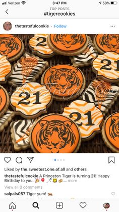 some cookies with tiger designs on them are sitting in a wicker basket and one has the number twenty two