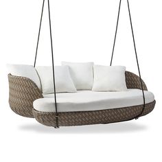 an outdoor swing chair with pillows on the front and back, hanging from two ropes