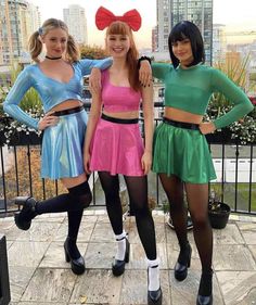 three girls in costumes posing for the camera