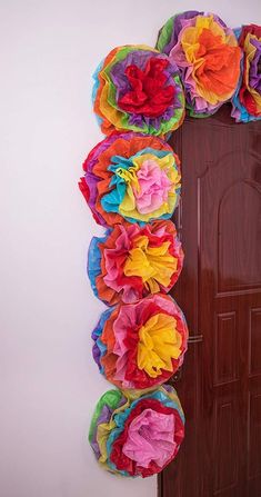 the door is decorated with colorful paper flowers