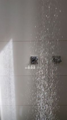 a shower head with water running down it's side and the words, evar mensagramm