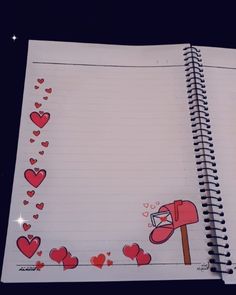 an open notebook with hearts drawn on it