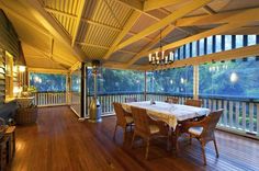 a dining room table and chairs on a wooden floor with an open patio door to the outside