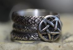 "A mysterious stack of 3 featuring a pentacle (11mm) on a floral patterned band, about 3.4mm wide. Two additional bands \"Dragonskin\" (4mm wide) and \"Vines\" (3.6mm wide) complete the set. All rings are solid sterling silver. Antiqued and polished. Any size. Sizing Note: Due to the combined width of this stacking set, it's advised to size up 1/2 size for the most comfortable fit. Gift boxed with a bow. :)" Pagan Prayer Beads, Pagan Prayer, Stacking Ring Set, Witchy Jewelry, Floral Vine, Prayer Beads, Stacking Ring, Stacking Rings, Rings Statement