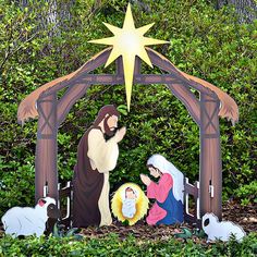 a nativity scene with the birth of jesus and three wise men, surrounded by greenery