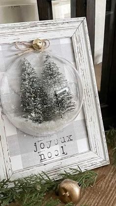 a christmas ornament in a white frame