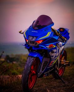 a blue motorcycle parked on top of a hill